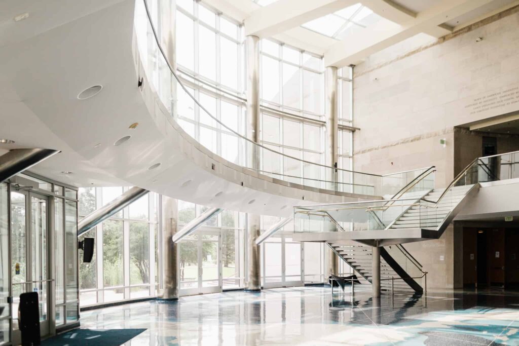 The Cable Center atrium, with a curved staircase under a full-height glass wall
